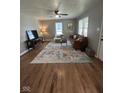 Bright living room features hardwood floors, ceiling fan, and a large window at 1722 Dawson St, Indianapolis, IN 46203
