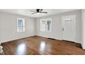 Bright living room featuring gleaming hardwood floors, neutral walls, and two large windows providing lots of light at 1722 Dawson St, Indianapolis, IN 46203
