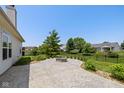 Backyard featuring a stone patio with fire pit and a fenced in yard with landscaping at 1854 Oconnor Ct, Avon, IN 46123