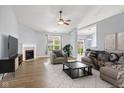 Bright living room featuring a fireplace, modern ceiling fan, and stylish furnishings at 1854 Oconnor Ct, Avon, IN 46123