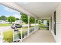 An inviting front porch with decorative railings offering a pleasant neighborhood view at 201 N 11Th St, Elwood, IN 46036
