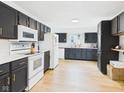 Modern kitchen with stainless steel appliances, dark cabinets, and granite countertops at 201 N 11Th St, Elwood, IN 46036