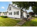 A view of the side and rear of the house with a small outdoor patio space at 201 N 11Th St, Elwood, IN 46036