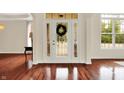 Bright foyer featuring hardwood floors, a decorative front door, and a large window with tree views at 2592 Highmount Ct, Carmel, IN 46033