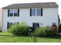 The home's backyard features a well maintained lawn with a black chainlink fence at 2628 Newaygo Dr, Indianapolis, IN 46217