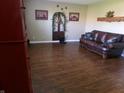 Cozy living room with hardwood floors and a comfortable leather sofa, ideal for relaxing and entertaining guests at 2628 Newaygo Dr, Indianapolis, IN 46217