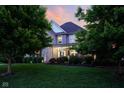 Beautiful two-story home with lush green lawn and mature trees in a serene setting at 2898 Violet W Ct, Columbus, IN 47201