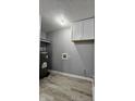 Laundry area featuring a water heater, hook ups, and wood grain flooring at 3305 E 30Th St, Indianapolis, IN 46218