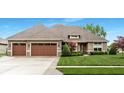 Traditional home with well-maintained lawn and mature landscaping including a two car garage at 3335 Guilford Ln, Plainfield, IN 46168