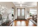Bright foyer with hardwood floors, decorative lighting, and a view into the dining room at 3335 Guilford Ln, Plainfield, IN 46168
