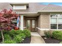 Inviting home entrance with a decorative front door, stone walkway, and lush landscaping at 3335 Guilford Ln, Plainfield, IN 46168