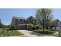 Charming two-story home with a brick-accented facade, attached garage and well-maintained landscaping at 409 Spring Green Pl, Indianapolis, IN 46229