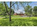 Spacious home with lush green lawn and mature trees providing ample shade and a serene setting at 4614 Thornleigh Dr, Indianapolis, IN 46226