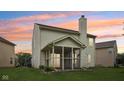 Backyard featuring a screened-in porch and lush green lawn, perfect for outdoor relaxation and entertainment at 513 Sun Catcher Dr, Avon, IN 46123