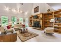 Bright living room featuring a fireplace with built-in bookshelves and large windows with natural light and neutral colors at 5326 White Marsh Ln, Indianapolis, IN 46226