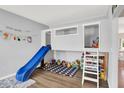 Bright playroom with slide, loft area, and ample storage for toys at 5420 Orwell Ct, Indianapolis, IN 46239