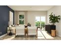 Bright living room with stylish furniture, including chairs, sofa, and an outdoor view at 647 Bridgeman Rd, Avon, IN 46123