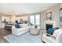 Bright living room with fireplace, large window, and open concept to the kitchen at 7595 Bluegill Dr, Noblesville, IN 46062