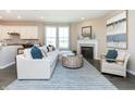 Open living room with view of kitchen and dining area at 7595 Bluegill Dr, Noblesville, IN 46062