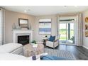 Cozy living room with fireplace and sliding glass doors to the backyard at 7595 Bluegill Dr, Noblesville, IN 46062