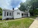 Charming single-story home with a well-manicured lawn, covered porch and an attached one-car garage at 7607 E 46Th St, Indianapolis, IN 46226