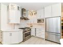 Modern kitchen features white cabinets, marble countertops, stainless steel appliances, and designer backsplash at 7775 N Meridian St, Indianapolis, IN 46260