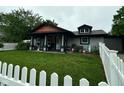 Inviting home with a cozy front porch and a lovely white picket fence at 9527 Pepperidge Dr, Indianapolis, IN 46235