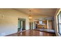 Open-concept living room with hardwood floors and views into the adjacent kitchen area at 9730 English Oak Pl, Indianapolis, IN 46235