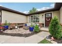 Inviting front porch with stylish outdoor furniture and decorative plants for relaxing at 976 Santa Maria Dr, Greenwood, IN 46143