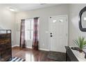 Bright entryway featuring hardwood floors, a front door with glass panels, and elegant decor at 9771 Blue Violet Dr, Noblesville, IN 46060