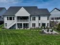 Spacious backyard with a patio, firepit, and lush green lawn at 987 Oak Terrace Rd, Westfield, IN 46074