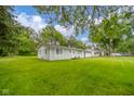 Charming single-story home with a large well-maintained lawn and mature trees at 10097 N Balfer E Dr, Fortville, IN 46040