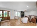 Bright living room with wood floors, a brick fireplace, and comfortable seating at 10274 S 400 W, Pendleton, IN 46064