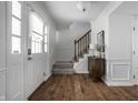 Bright foyer features hardwood floors, stairway, and door with leaded glass window at 10833 Marquette Rd, Zionsville, IN 46077