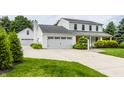 Beautiful home with a spacious driveway, two-car garage and a separate one car garage, and well manicured lawn at 10833 Marquette Rd, Zionsville, IN 46077