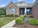 Charming front entrance with well-maintained landscaping and a blue front door at 11700 Harvest Moon Dr, Noblesville, IN 46060