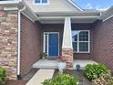Inviting front porch with a blue door, stone accents and fresh landscaping at 11700 Harvest Moon Dr, Noblesville, IN 46060