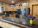 Spacious kitchen featuring custom wood cabinets, granite countertops, and stainless steel appliances at 11898 N 200 W, Fountaintown, IN 46130