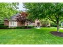 Landscaped front yard with mature trees and shrubs surrounding a classic brick home at 14274 Matt St, Carmel, IN 46033