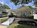 Charming house featuring a cozy front porch and a well-manicured landscaped yard at 1440 Sycamore St, Columbus, IN 47201