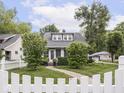 Beautiful house showcasing a lush green lawn, mature trees, and a quaint walkway to the front door at 150 E 46Th St, Indianapolis, IN 46205
