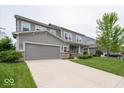 Two-story home with a two-car garage, green lawn, and walkway to covered front porch at 15675 Myland Dr, Noblesville, IN 46062