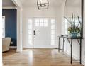 Bright entryway with hardwood floors, white trim, and a stylish console table with mirror at 1820 N 1100 E, Sheridan, IN 46069