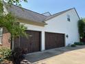 Spacious two car garage featuring paneled doors on a house with white siding and partial brick construction at 18967 Mill Grove Dr, Noblesville, IN 46062