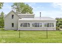 Home featuring a sunroom with a metal roof and well-maintained lawn at 20530 Victory Chapel Rd, Noblesville, IN 46060