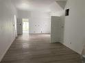 Bright living room featuring neutral walls, wooden floors, and a doorway leading to another room at 243 Iowa St, Indianapolis, IN 46225