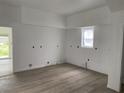 Bright living room featuring neutral walls, wooden floors, and a window for light at 243 Iowa St, Indianapolis, IN 46225