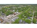 High angle of a charming community with homes, trees, and railroad tracks nearby at 30 N Depot St, New Palestine, IN 46163