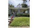 Inviting two-story home with a cozy covered porch and landscaped front yard at 303 Walnut St, Greenfield, IN 46140