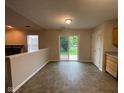 Open dining area with sliding glass doors and view to yard and patio, neutral paint and half wall to living space at 356 Seabreeze Cir, Avon, IN 46123